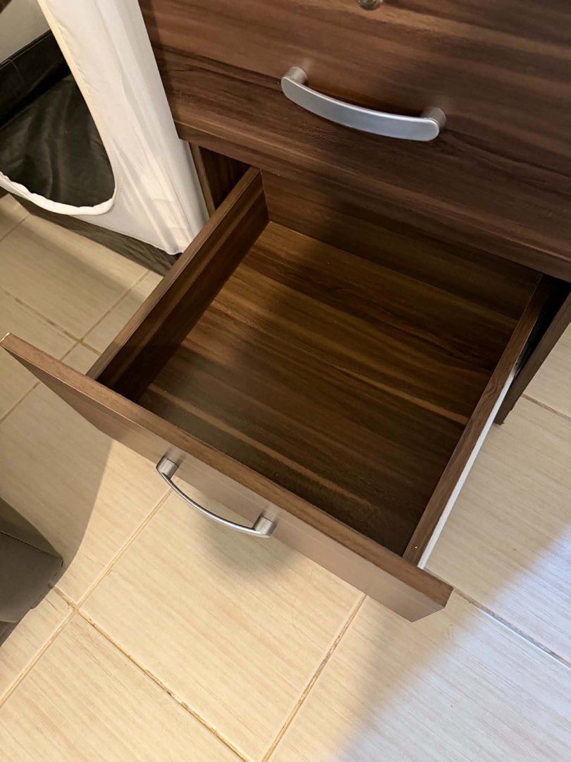 Wardrobe Cabinet with Drawers (Category: Shelves, Cabinets & Racks) located in Mandaluyong City. Submitted by artyreal (Listing ID 1470246322, Image 2). Description: - Dark wood grain finish - 1 hanging compartment with top shelf - 2 spacious lower drawers - Built-in lock on top drawer for security - Sleek silver-toned metal handles - Sturdy wooden construction - Compact size, ideal for small spaces.