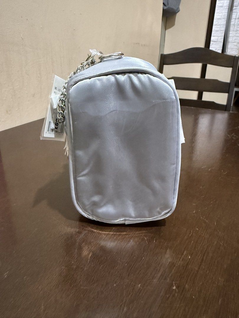 WEGO Your Fan Doll Storage Bag Silver 10cm (Category: Accessory Holder, Box & Organizers) located in Pasig City. Submitted by boredtakoyaki (Listing ID 1470247233, Image 2). Description: - Brand: WEGO - Color: Silver - Size: Fits 10cm plush dolls - Features: Clear front window & white ribbon corset lacing on the side - Inclusion: Top keychain attachment for easy hanging - Condition: Brand new with original store tags attached.