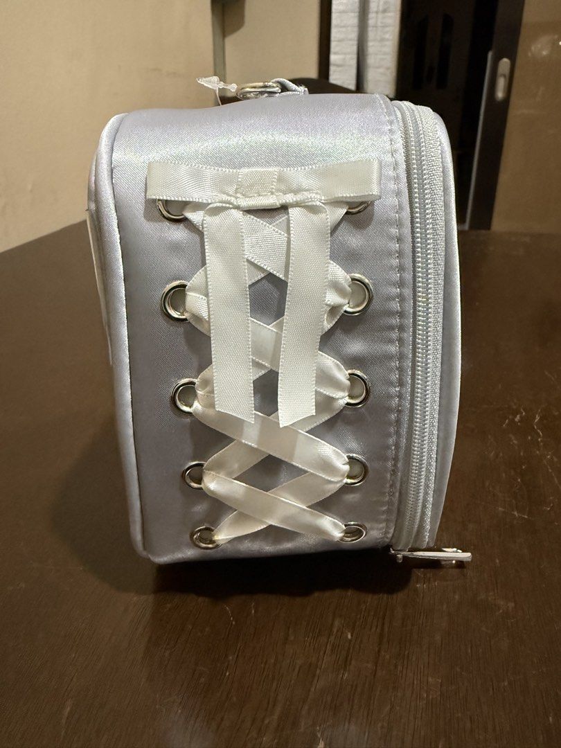 WEGO Your Fan Doll Storage Bag Silver 10cm (Category: Accessory Holder, Box & Organizers) located in Pasig City. Submitted by boredtakoyaki (Listing ID 1470247233, Image 3). Description: - Brand: WEGO - Color: Silver - Size: Fits 10cm plush dolls - Features: Clear front window & white ribbon corset lacing on the side - Inclusion: Top keychain attachment for easy hanging - Condition: Brand new with original store tags attached.