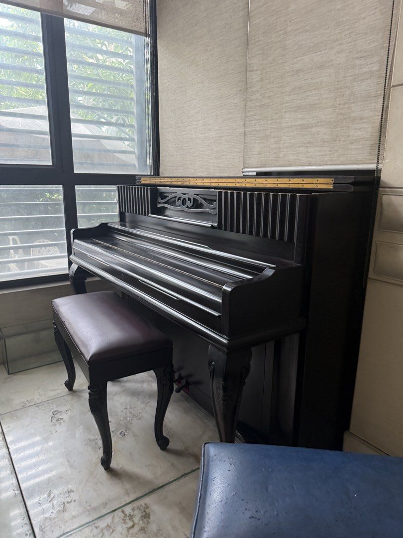 Weinstein & Sons Upright Piano with extra Bench (Category: Musical Instruments) located in Manila. Submitted by korprincess (Listing ID 1470347996, Image 1). Description: - Brand/Model: Vintage Weinstein & Sons upright piano - Finish: Dark wood with classic cabinet design, decorative carved legs, and front panel fluting - Inclusions: Matching piano bench with blue upholstered seat - Condition: Good for practice or home decor; needs tuning and min
