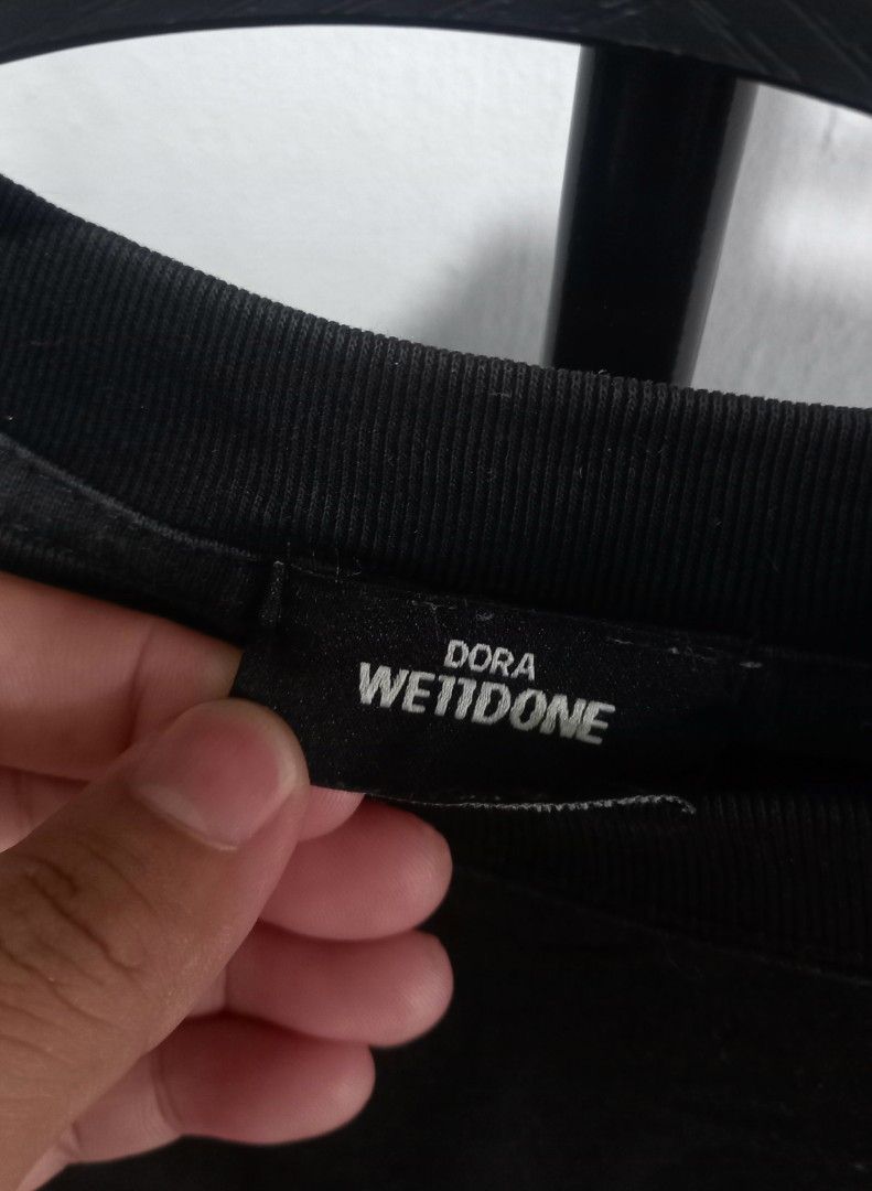 WellDone Black Graphic T-Shirt Oversized (Category: Tshirts & Polo Shirts ) located in Tarlac. Submitted by den420 (Listing ID 1470220556, Image 3). Description: - Brand: WellDone (Dora tag) - Color: Black - Fit: Relaxed fit with crew neck and short sleeves - Design: Bold blue abstract graphics and large text on the back, with a smaller matching logo on the front left chest.