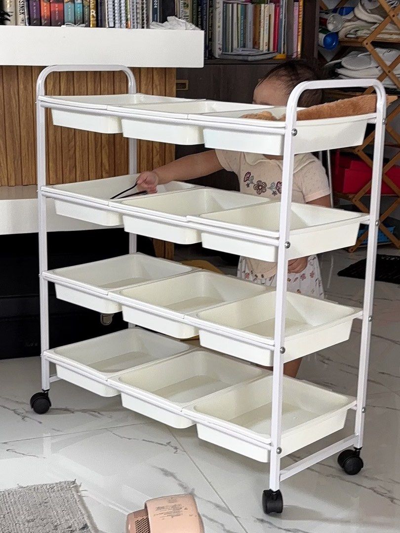 White 4-Tier Rolling Storage Cart with Plastic Bins (Category: Educational & Learning Toys) located in Rodriguez. Submitted by anjloving (Listing ID 1470290693, Image 2). Description: - 4-tier rolling storage cart with smooth-sliding plastic bins - Sturdy white metal frame built for everyday use - 4 caster wheels for easy mobility around the house - Multi-purpose: great for toys, craft supplies, office gear, or kitchen items - Compact design help
