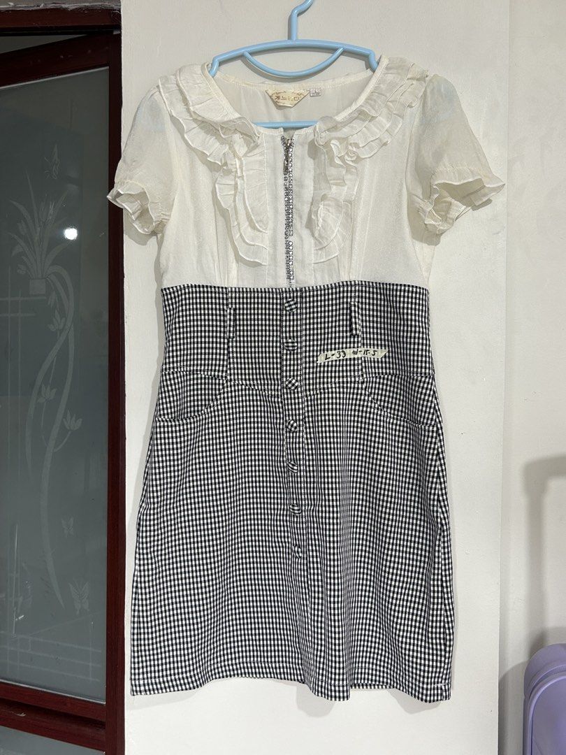 White and Black Gingham Ruffle Dress (Category: Dresses) located in Pasig City. Submitted by eddwuhrd (Listing ID 1470167462, Image 1). Description: - Style: Short sleeve dress with white ruffled top and black-and-white gingham skirt - Closure: Half-zip front with sparkling rhinestone details along the zipper teeth - Design: High waist cut with decorative button accents down the front - Size: L (165/88A) - Condition: Excellent, ready to wear.