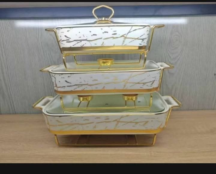 White and gold marble design ceramic chafing dish buffet server set (Category: Dinnerware & Cutlery) located in Caloocan City. Submitted by silentowl_68d652 (Listing ID 1470273877, Image 1). Description: - 3-tier white ceramic buffet server with luxurious gold marble patterns and sturdy metal stands - Includes glass lids for each tier to lock in heat and freshness - Built-in candle warmer holders underneath to keep your food warm effortlessly - H