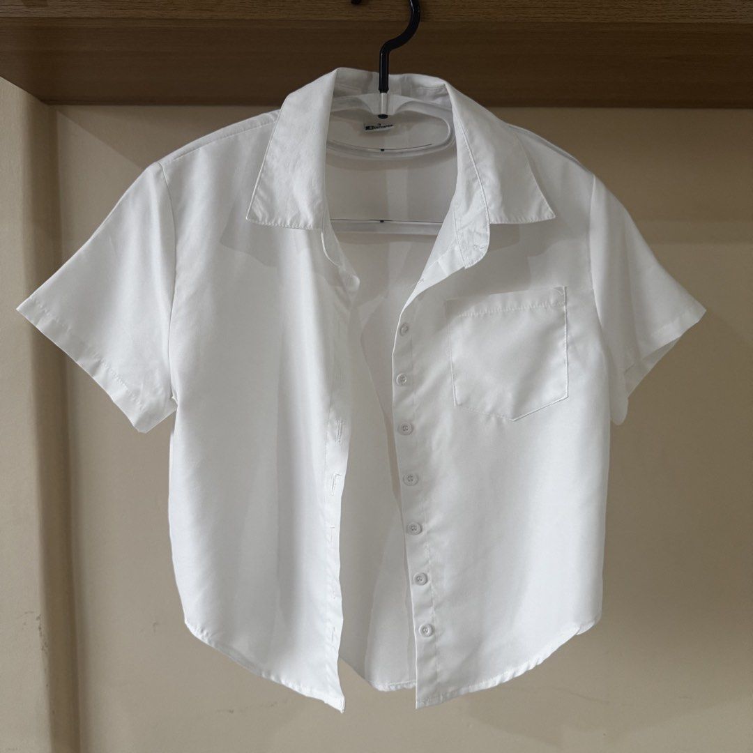 White Button Shirt Top with front pocket (Category: Blouses) located in Mandaluyong City. Submitted by cloudycloset09 (Listing ID 1470169870, Image 1). Description: Used several times but I would say is still in good condition. All 7 buttons are in tact, no permanent flaws. This can fit XS-MEDIUM frame. I can give discount if you buy this with the black version of this :).