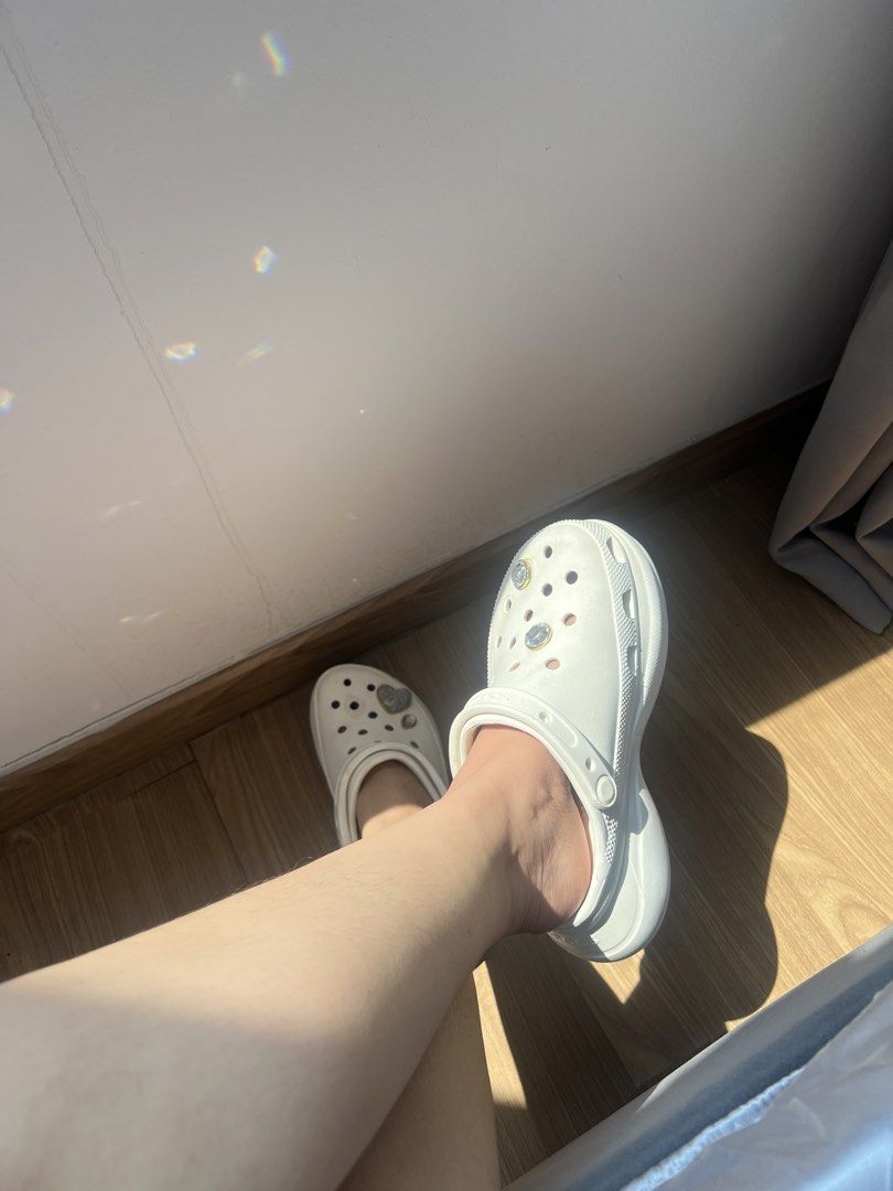 White Crocs Platform Clogs with Jibbitz Charms (Category: Slippers and slides) located in Makati City. Submitted by warm.abc123 (Listing ID 1470181141, Image 3). Description: - Authentic White Crocs Platform Clogs - Features sparkly Jibbitz charms (glittery heart and clear gems) - Classic slip-on design with extra height and iconic comfort footbed - Condition: Uppers are very clean, with minor light wear on the soles - Perfect for daily casual we
