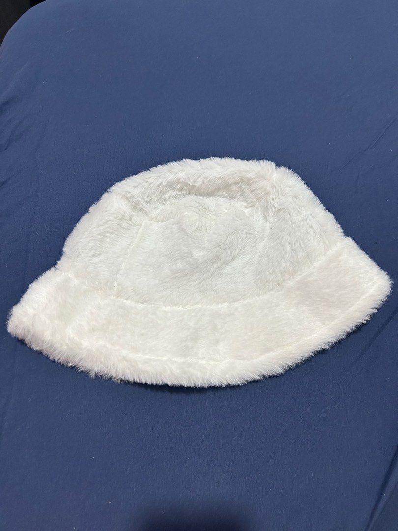 White Faux Fur Bucket Hat (Category: Hats & Beanies) located in Makati City. Submitted by aizy_sell (Listing ID 1470267318, Image 1). Description: - Color: Fluffy white with black fabric lining inside - Material: Super soft faux fur, nice and warm for winter - Size: Standard adult size - Condition: Brand new, clean, and never worn out - Features: Includes original interior tag.