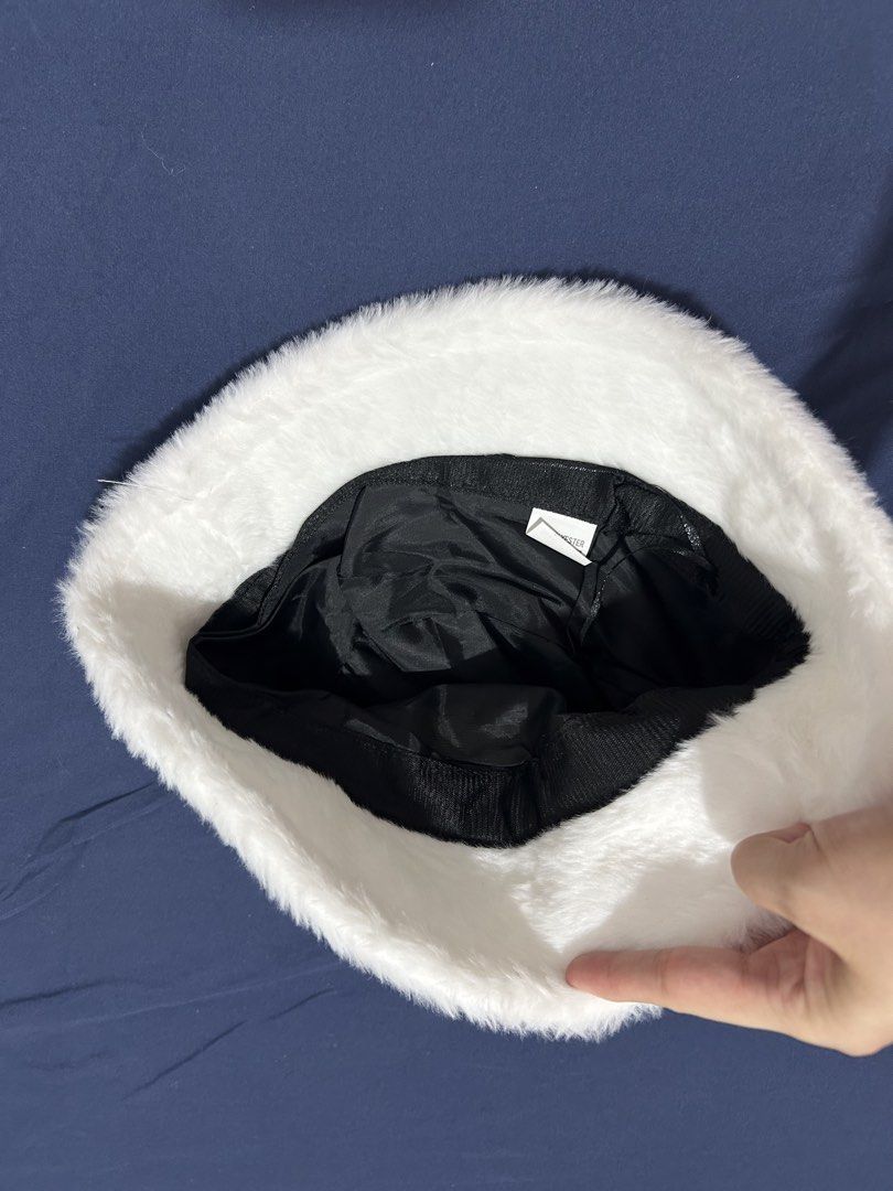 White Faux Fur Bucket Hat (Category: Hats & Beanies) located in Makati City. Submitted by aizy_sell (Listing ID 1470267318, Image 3). Description: - Color: Fluffy white with black fabric lining inside - Material: Super soft faux fur, nice and warm for winter - Size: Standard adult size - Condition: Brand new, clean, and never worn out - Features: Includes original interior tag.