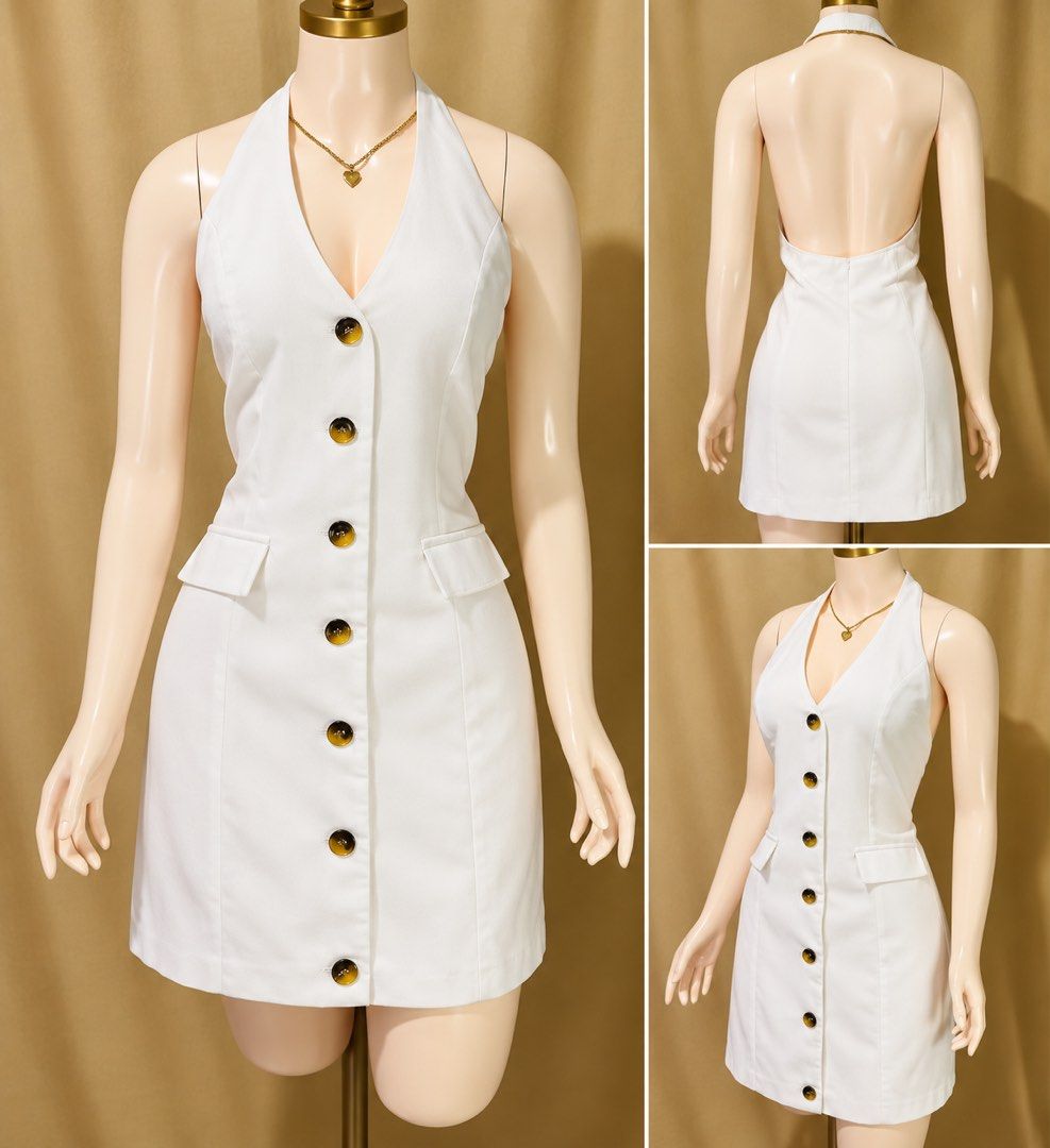 White Halter Neck Button Up Mini Dress (Category: Dresses) located in Manila. Submitted by babii08 (Listing ID 1470232587, Image 1). Description: - Color: Crisp White - Style: Halter neck mini dress with a deep V-neckline and open back - Details: Tortoiseshell front buttons and decorative hip pockets - Fit: Structured, flattering mini length - Occasion: Versatile for daytime events or evening parties - Condition: Excellent, ready to wear.