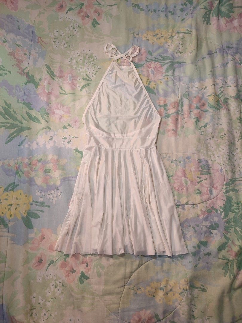 White Halter Neck Mini Satin Dress (Category: Dresses) located in Jaen. Submitted by roxantiago (Listing ID 1470192723, Image 1). Description: - Color: White - Style: Halter neck, sleeveless, fit-and-flare mini dress - Details: Deep scoop back, adjustable tie straps, and a flared skirt xs to s - Versatility: Great for casual day wear or stylish nights out.