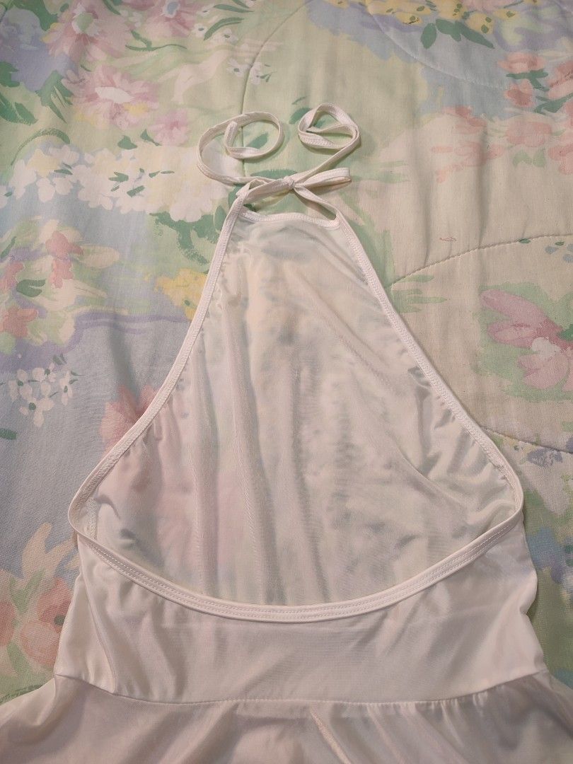 White Halter Neck Mini Satin Dress (Category: Dresses) located in Jaen. Submitted by roxantiago (Listing ID 1470192723, Image 3). Description: - Color: White - Style: Halter neck, sleeveless, fit-and-flare mini dress - Details: Deep scoop back, adjustable tie straps, and a flared skirt xs to s - Versatility: Great for casual day wear or stylish nights out.