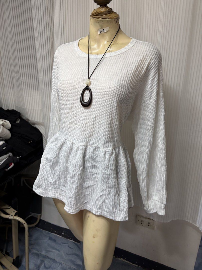 White long sleeve waffle knit peplum top (Category: Longsleeves) located in General Trias. Submitted by crissy9053136 (Listing ID 1470229002, Image 1). Description: - Color: White - Material: Lightweight waffle knit fabric - Design: Round neckline, dropped shoulders, fitted bodice with a flared peplum hem - Style: Casual and versatile - Pairing: Perfect to match with denim jeans or shorts for everyday wear.