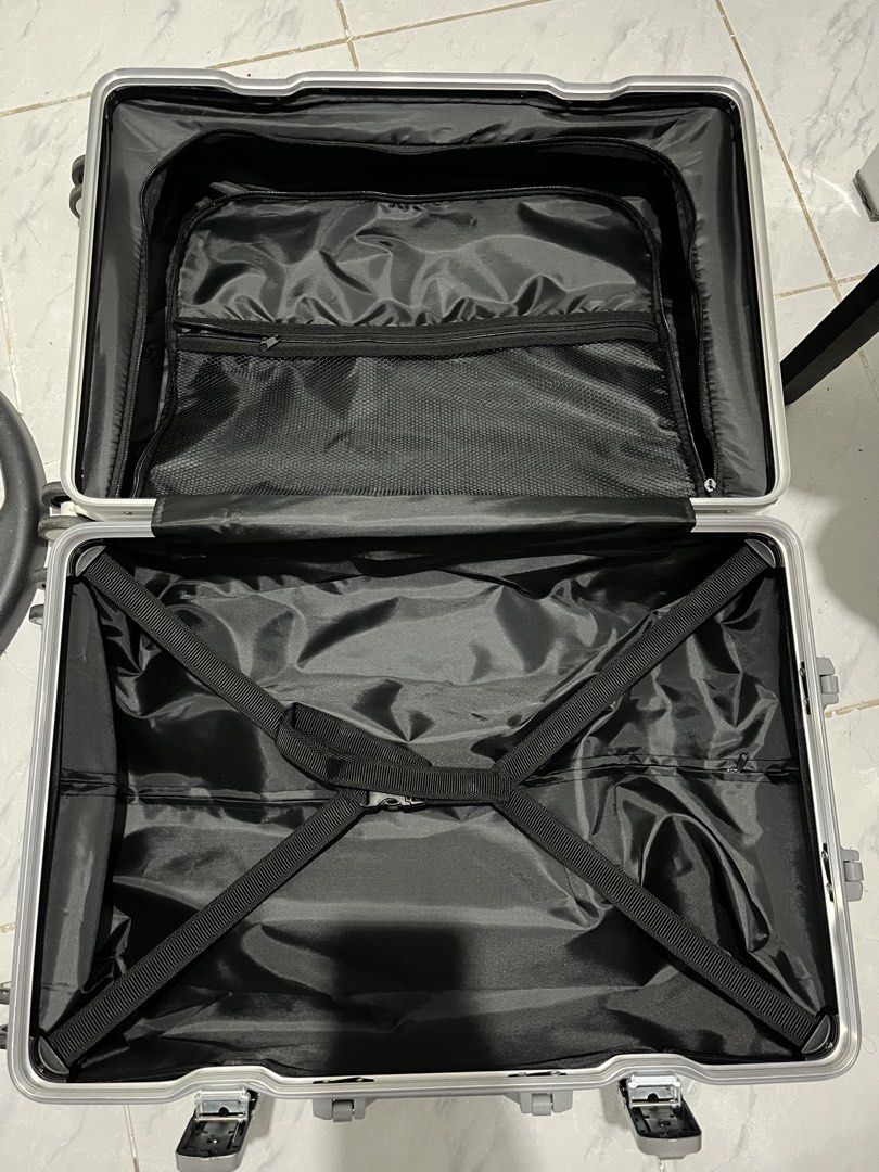 White luggage (Category: Luggage) located in Marikina City. Submitted by patpatndls (Listing ID 1470270762, Image 3). Description: - Color: White - Size: Medium (23-24 inches) - Condition: Layered condition 4 - Material: Sturdy hardcase exterior - Security: Dual latch locks on top - Interior: Black lining with cross-straps and zippered mesh pockets - Wheels: Smooth rolling spinner wheels - Negotiable price.