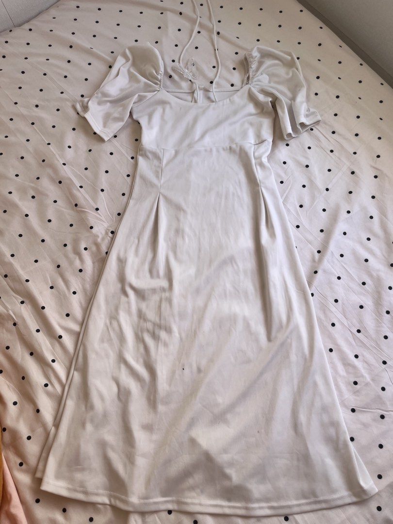 White midi dress puff sleeves halter neck (Category: Dresses) located in Manila. Submitted by chimcheese (Listing ID 1470154366, Image 1). Description: - Color & Style: White midi dress with a fitted bodice and flared skirt - Neckline & Sleeves: Square neckline with trendy puff sleeves and delicate halter straps - Special Detail: Sheer lace butterfly accent at the back - Fabric: Soft, stretchy, and comfortable material - Length: Midi length (hits