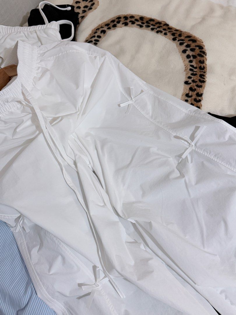 White parachute pants with bow details size XL (Category: Jeans) located in Taguig. Submitted by mengxir20193848 (Listing ID 1470250751, Image 3). Description: - Size: XL (Tag: 170/76A) - Color: White - Material: Lightweight nylon - Waist: Elastic waistband with adjustable drawstring - Cuffs: Elastic ankles with drawstrings - Details: Cute little bows sewn along the sides, plus a convenient right back pocket - Style: Super comfy and perfect for c
