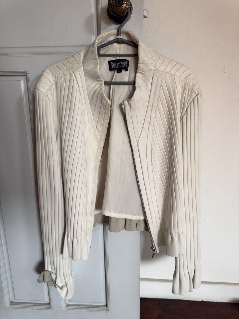 White Pleated Leather Jacket (Category: Coats, Jackets and Outerwear) located in Quezon City. Submitted by socutexx (Listing ID 1470220214, Image 1). Description: - Brand/Model: Beverly Hills Clothing Co. - Color: White - Material: Genuine leather with polyester lining - Size: L - Design: Zip front, high collar, vertical pleated paneling, flared bell cuffs with raw edges - Care: Professional leather clean only - Condition: Light discoloration mar
