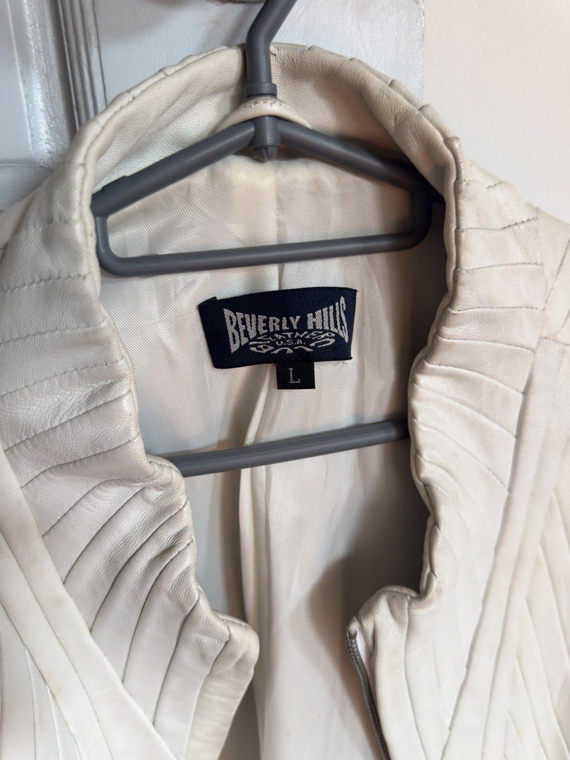 White Pleated Leather Jacket (Category: Coats, Jackets and Outerwear) located in Quezon City. Submitted by socutexx (Listing ID 1470220214, Image 2). Description: - Brand/Model: Beverly Hills Clothing Co. - Color: White - Material: Genuine leather with polyester lining - Size: L - Design: Zip front, high collar, vertical pleated paneling, flared bell cuffs with raw edges - Care: Professional leather clean only - Condition: Light discoloration mar