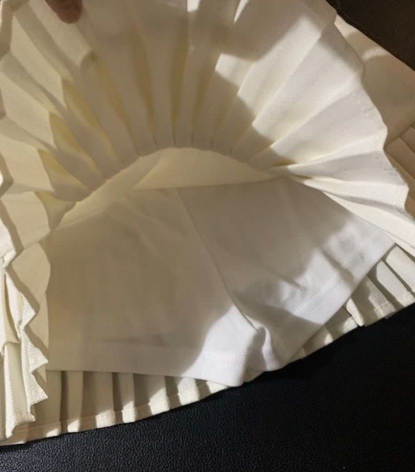White Pleated Skirt with Inner Shorts (Category: Skirts) located in Muntinlupa City. Submitted by clophilia (Listing ID 1470257400, Image 3). Description: - Color: White - Size: 27-28 (garterized at the back) - Style: High waist layered pleated skirt with built-in shorts (skort) - Details: Belt loops, elastic back, double-layer ruffle pleats at the hem - Condition: Excellent, clean with no flaws - Perfect for: Casual everyday wear and styling.