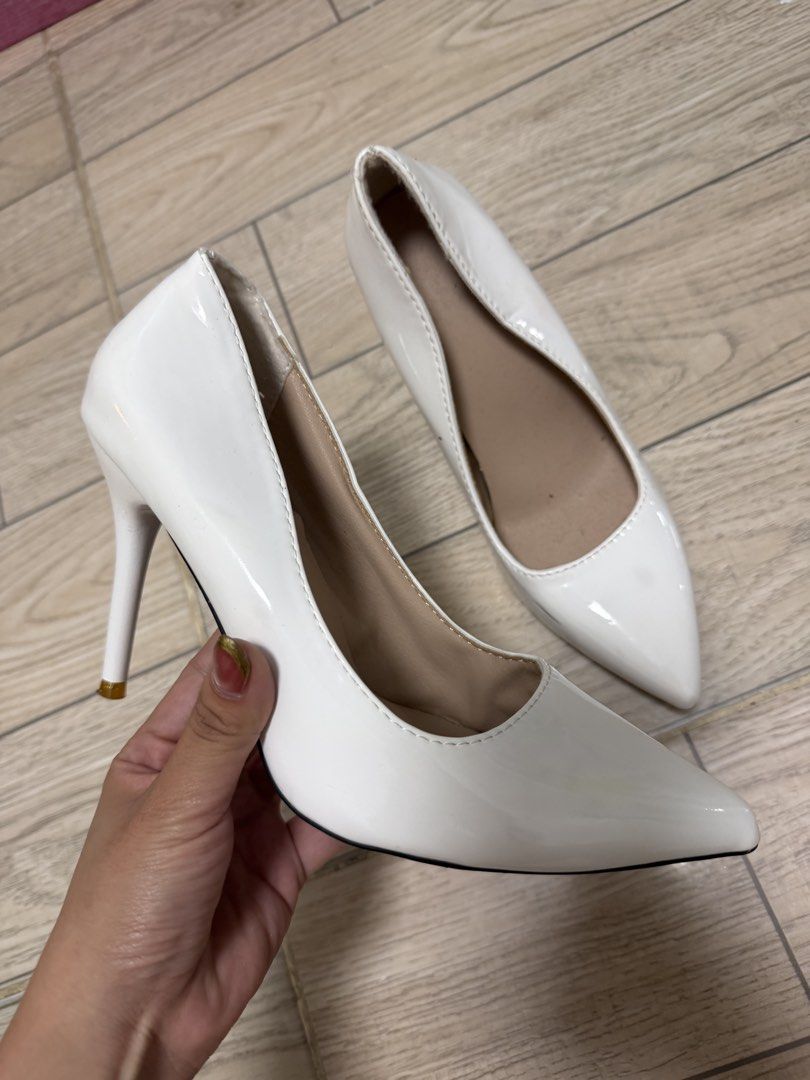 White Pointed Toe Stiletto Heels Size 38 (Category: Heels) located in Rizal. Submitted by kianapreloves (Listing ID 1470258364, Image 3). Description: - Color: White patent - Style: Classic pointy toe stiletto heels - Size: 38 (marked on sole) - Features: High heel, slip-on style, nude inner lining - Condition: Good, with a slight scuff mark on the side (refer to the last picture).