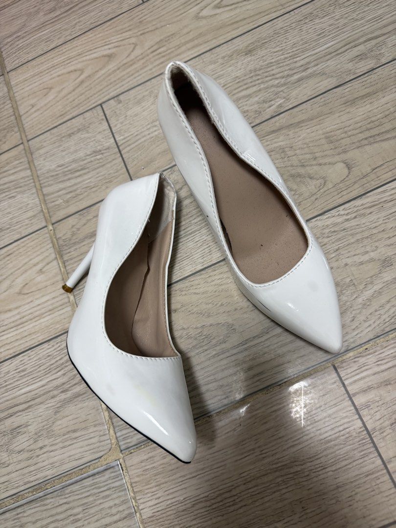 White Pointed Toe Stiletto Heels Size 38 (Category: Heels) located in Rizal. Submitted by kianapreloves (Listing ID 1470258364, Image 1). Description: - Color: White patent - Style: Classic pointy toe stiletto heels - Size: 38 (marked on sole) - Features: High heel, slip-on style, nude inner lining - Condition: Good, with a slight scuff mark on the side (refer to the last picture).