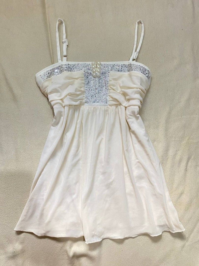 White Rhinestone Embellished Chiffon Camisole (Category: Sleeveless) located in Iloilo. Submitted by xya.xoxo28 (Listing ID 1470313186, Image 1). Description: - Color: White - Style: Camisole dress or top with a flowy fit - Details: Shiny rhinestone chest panels, faux-pearl center buttons, and side ruching - Straps: Thin and adjustable - Fabric: Soft chiffon lower section - Occasion: Ideal for nights out, parties, or special events.