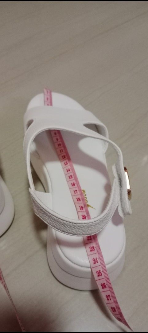 White Sandals (Category: Flats & Sandals) located in Mangaldan. Submitted by closetqwin (Listing ID 1470199770, Image 2). Description: - Color: Clean white - See 2nd picture for measurements - Material: Synthetic leather upper - Design: Chunky platform sole with a comfortable wedge heel - Closure: Gold-tone buckle on the ankle strap - Styling: Versatile design that matches shorts, jeans, and summer dresses.