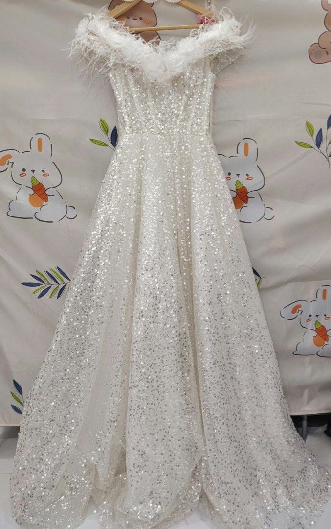 White Sequin Off-Shoulder Wedding Reception Dress with Feathers (Category: Evening dresses & gowns) located in Caloocan City. Submitted by jonnamae_339 (Listing ID 1470296144, Image 2). Description: - Color/Design: White sparkly sequin dress with fluffy feather-trimmed off-shoulder neckline - Occasion: Ideal for garden weddings and evening reception parties - Waist Fit (Lace-up): Fits 26 to 30 inches using the adjustable back ties - Waist Fit (Zi