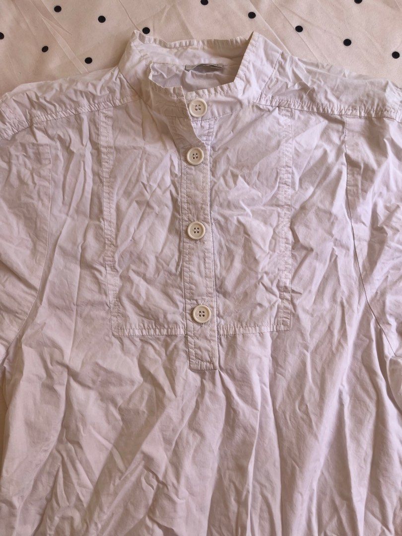 White Short Sleeve Mandarin Collar Blouse with Buttons (Category: Blouses) located in Manila. Submitted by chimcheese (Listing ID 1470153523, Image 2). Description: - Color: White - Style: Short sleeve button-up with Mandarin collar - Details: Four front buttons and structured front panel - Fit: Relaxed and comfortable - Pairing: Great for casual outfits with skirts or high-waisted jeans.