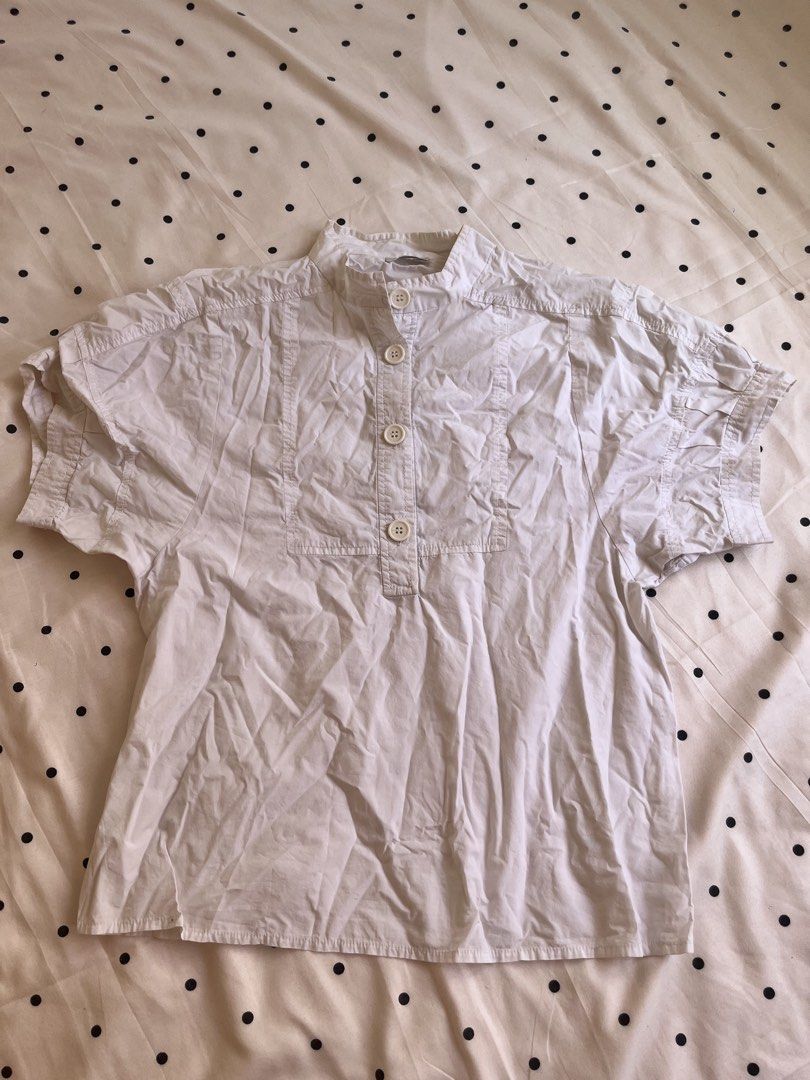 White Short Sleeve Mandarin Collar Blouse with Buttons (Category: Blouses) located in Manila. Submitted by chimcheese (Listing ID 1470153523, Image 1). Description: - Color: White - Style: Short sleeve button-up with Mandarin collar - Details: Four front buttons and structured front panel - Fit: Relaxed and comfortable - Pairing: Great for casual outfits with skirts or high-waisted jeans.