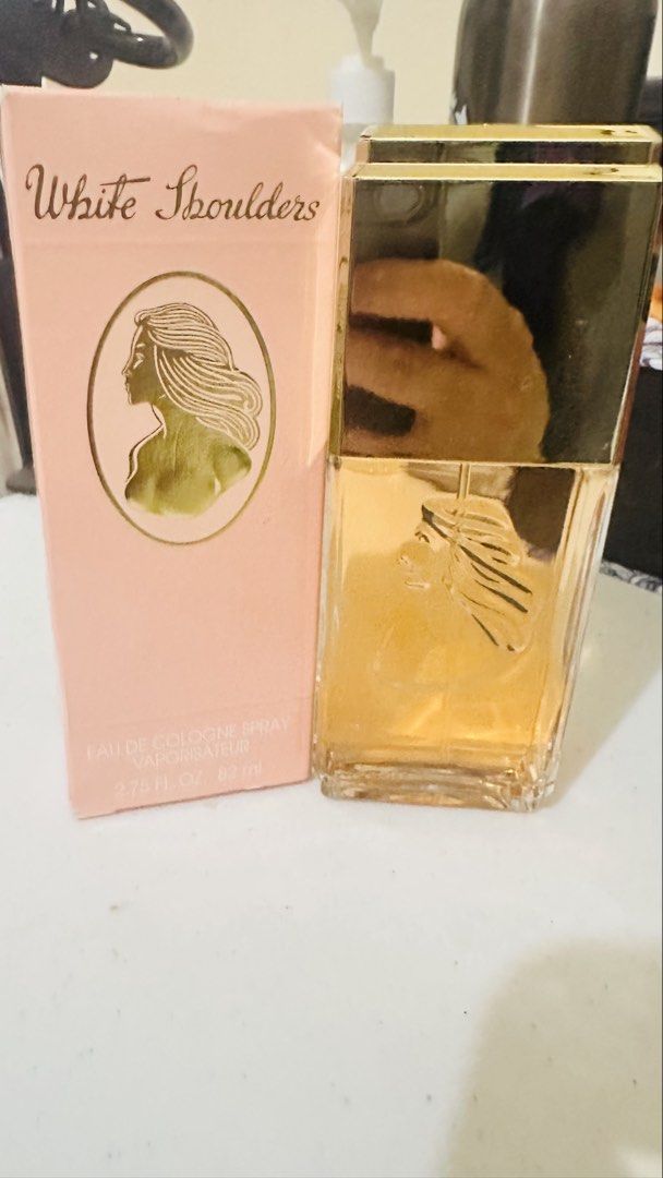 White Shoulders Eau De Cologne Spray (Category: Fragrance & Deodorants) located in Candelaria. Submitted by zillerortsac (Listing ID 1470212084, Image 1). Description: Original (USA Source) - Authentic vintage White Shoulders eau de cologne by Evyan - Generous 2.75 fl oz / 82 ml bottle size - Timeless floral fragrance with classic appeal - Elegant glass bottle featuring a golden cap and embossed cameo detail - Comes with the original pink cardboa