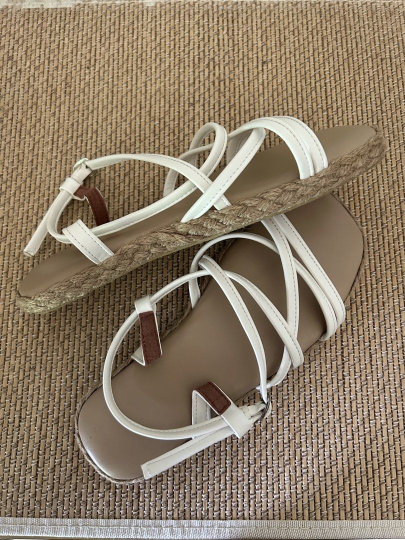 White Strappy Flat Sandals with Espadrille Trim (Category: Flats & Sandals) located in Legazpi City. Submitted by jjacob_018 (Listing ID 1470215307, Image 2). Description: - Style: White strappy flat sandals with easy slip-on design and adjustable buckle - Details: Tan insoles, stylish espadrille trim, and brown strap accents - Best For: Casual warm-weather outfits and everyday wear.