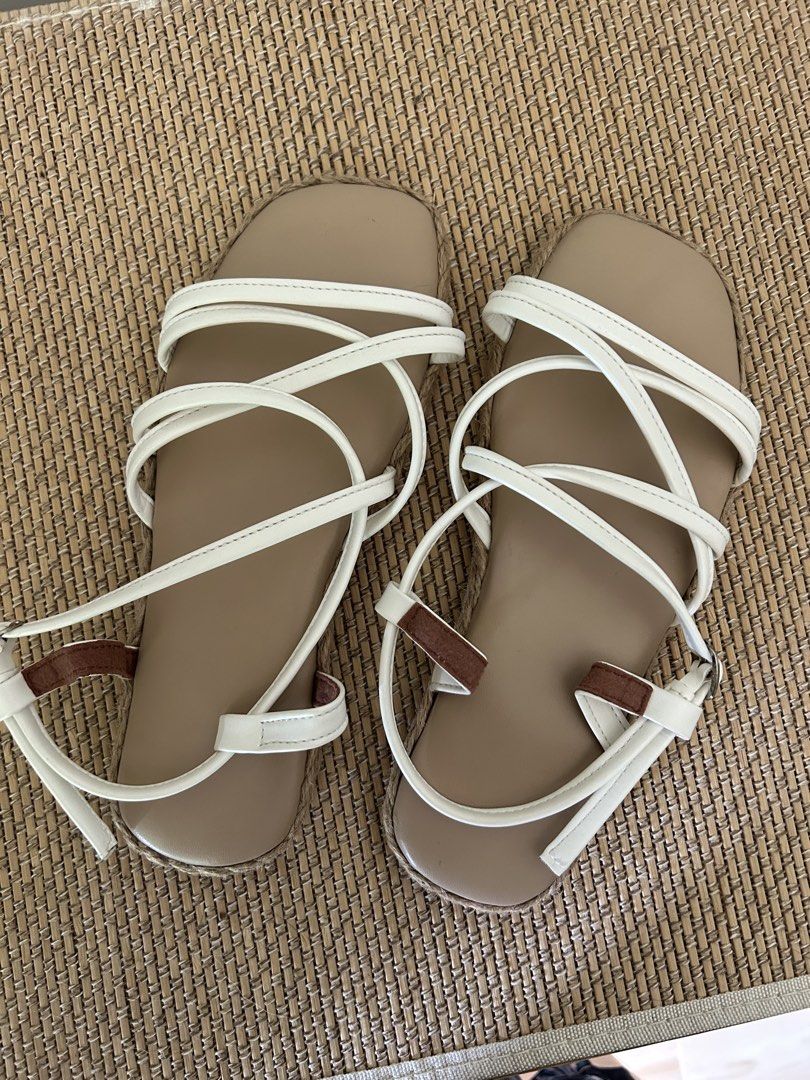 White Strappy Flat Sandals with Espadrille Trim (Category: Flats & Sandals) located in Legazpi City. Submitted by jjacob_018 (Listing ID 1470215307, Image 1). Description: - Style: White strappy flat sandals with easy slip-on design and adjustable buckle - Details: Tan insoles, stylish espadrille trim, and brown strap accents - Best For: Casual warm-weather outfits and everyday wear.