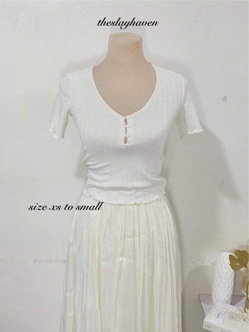 White V-Neck Short Sleeve Button-Front Ribbed Top (Category: Shirts) located in Manila. Submitted by biacakes (Listing ID 1470261984, Image 1). Description: - Color: White - Material: Stretchy ribbed fabric - Fit: XS to S (fitted, waist-length) - Details: Short sleeves, V-neck, functional front buttons with chic cutout accents - Condition: Brand new / Excellent - Note: Skirt in photos is sold separately.