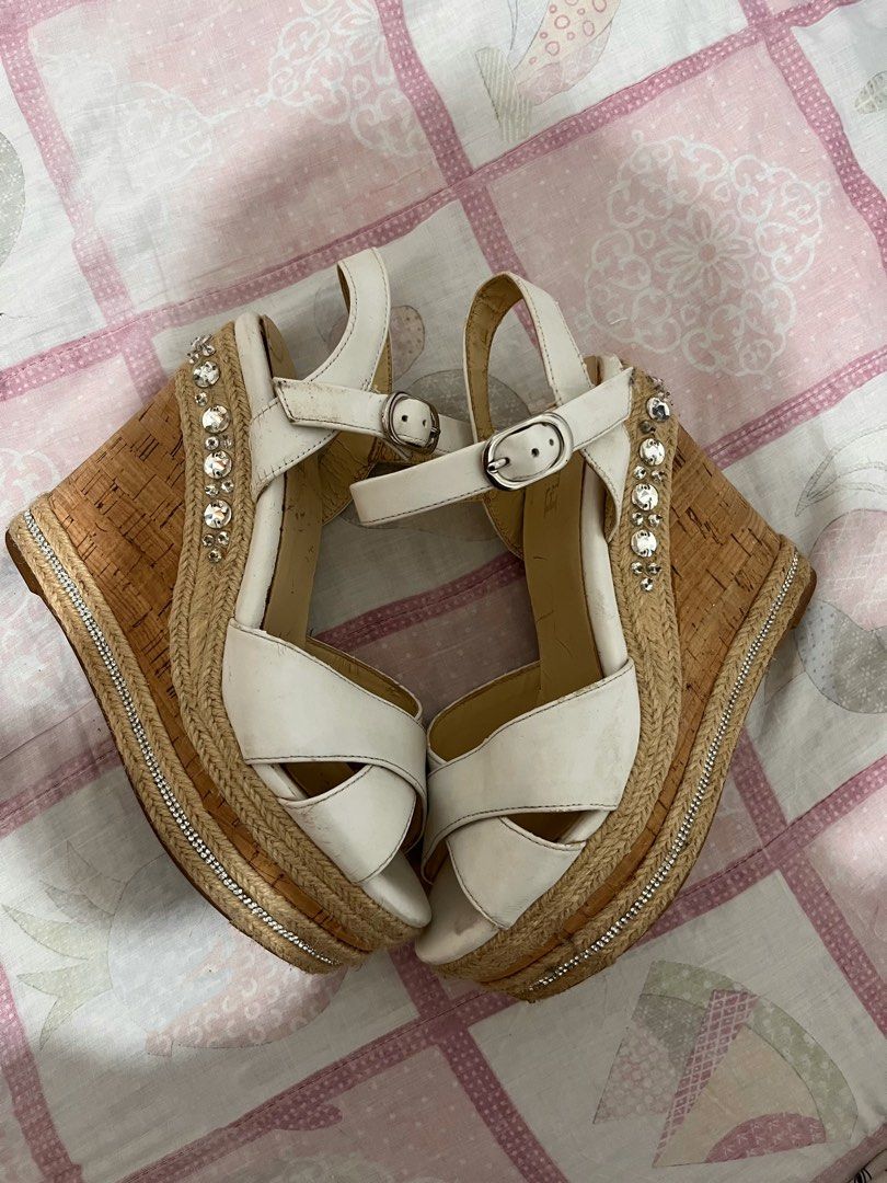White Wedge Sandals with Rhinestone and Cork Platform (Category: Flats & Sandals) located in Manila. Submitted by brightwind_62659f (Listing ID 1470249221, Image 1). Description: - Style: White platform sandals with a high cork wedge heel - Bling: Rhinestone embellishments on the back heel and silver rhinestone chain trim along the platform - Closure: Adjustable ankle buckle strap - Condition: Minor scuffs and wear marks on the inner sole and str