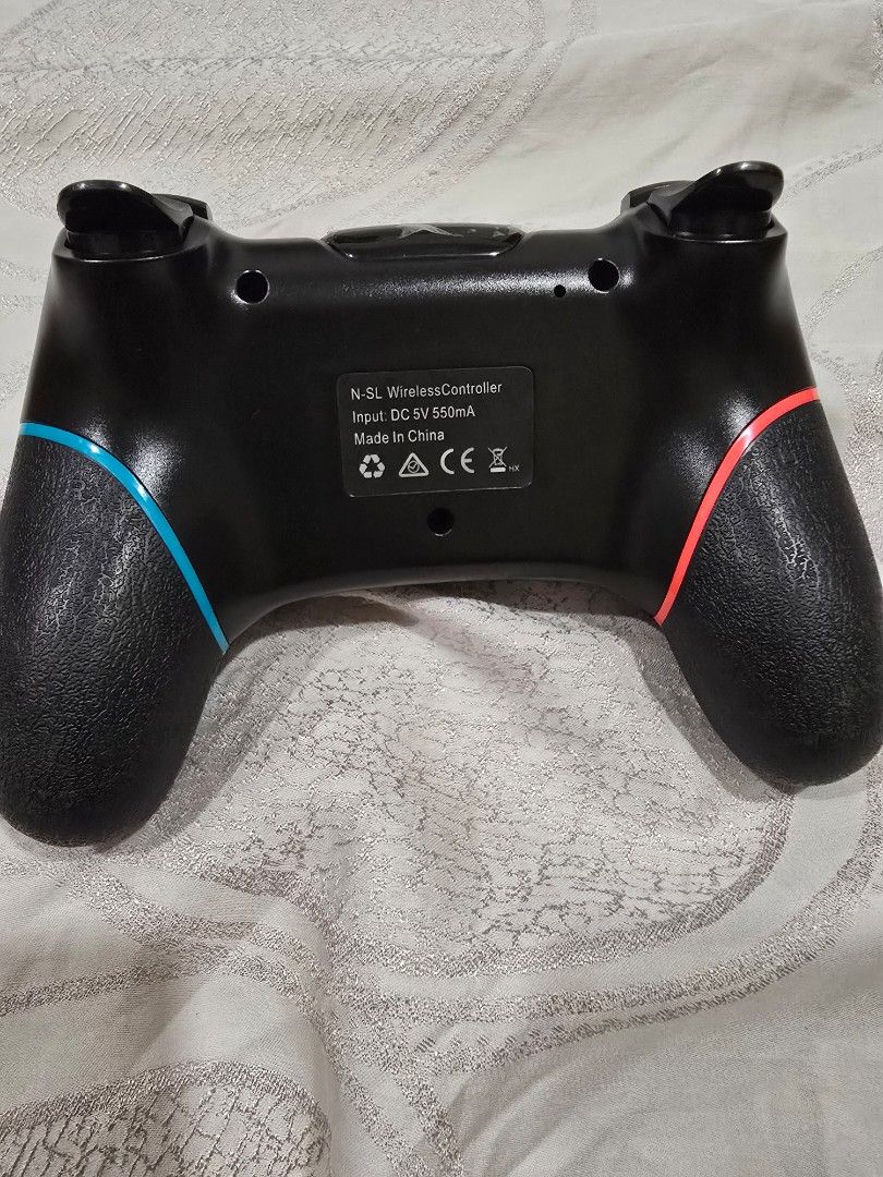 Wireless Controller (Category: Controllers) located in Klang. Submitted by press_startgame (Listing ID 1470189612, Image 2). Description: - Color: Black with neon blue and red grips - Compatibility: pc and android phone - Layout: Standard ABXY, dual analog sticks, D-pad, and extra center buttons - Comfort: Textured handles for better grip during long gaming sessions - Power: 5V 550mA input, easy to connect and play.