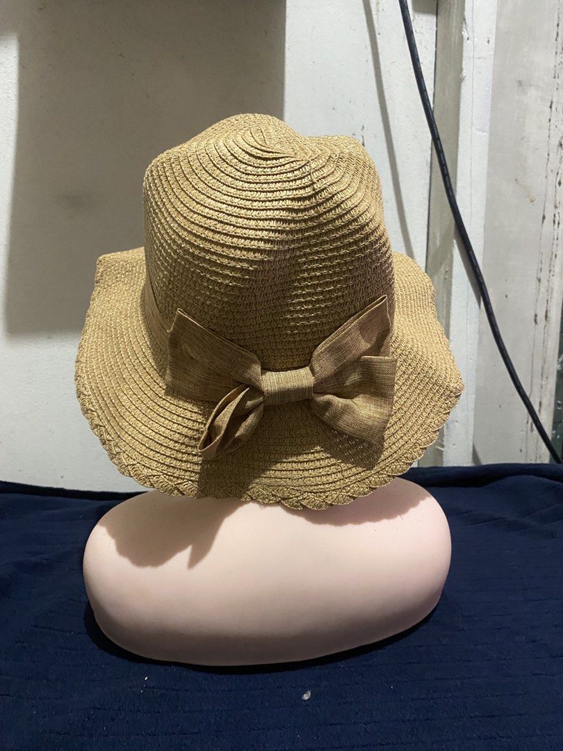 Woven Straw Sun Hat With Bow Detail (Category: Hats & Beanies) located in Manila. Submitted by resi.diaz (Listing ID 1470319977, Image 3). Description: - Color: Classic tan with a matching ribbon and bow on the back - Brim: Trendy scalloped edge for extra style and sun protection - Material: 100% lightweight paper straw - Fit: Built-in adjustable drawstring band for a secure and comfortable fit - Use: Ideal shade accessory for beach trips, picnic