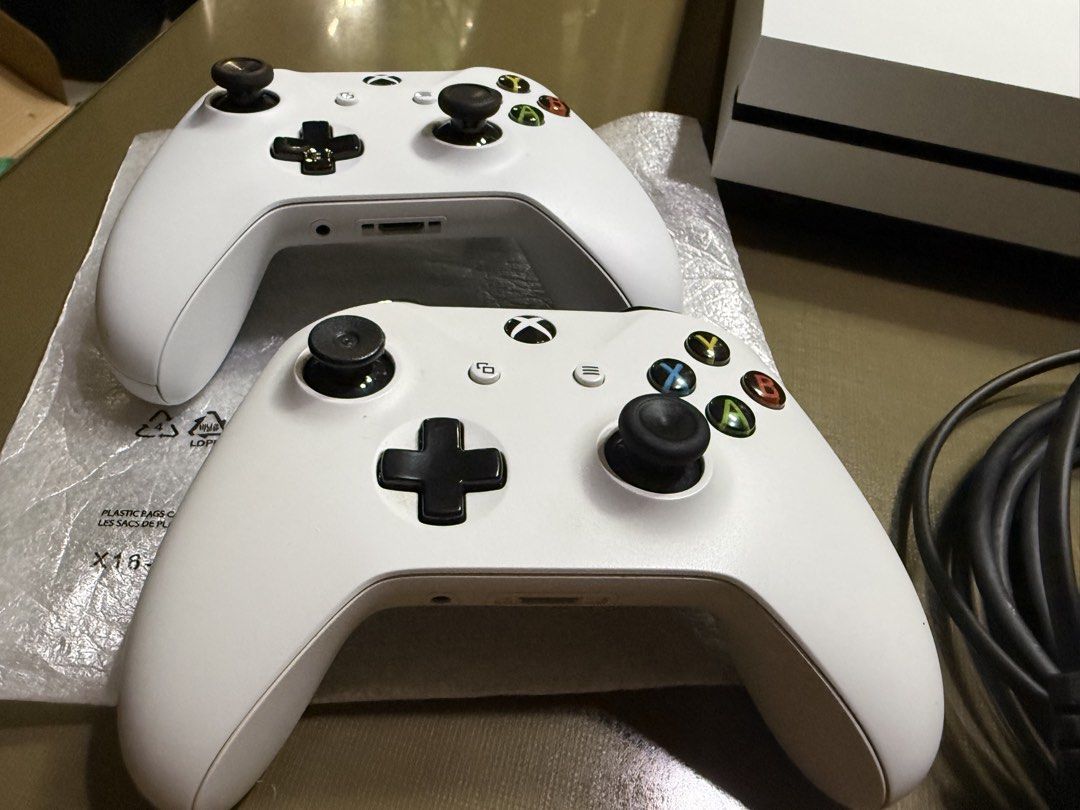 Xbox One S Bundle with Controllers and Games (Category: Xbox) located in Bulacan. Submitted by jmfranco_1101_newer (Listing ID 1470221080, Image 2). Description: - White Xbox One S console in clean condition with all back ports intact - Includes 2 white wireless controllers complete with thumbsticks and button pads (one is bnew) - Power cable and HDMI cable included - Comes with 8 popular games: Dragon Age II, Dragon Age Inquisition, Prototype 2,
