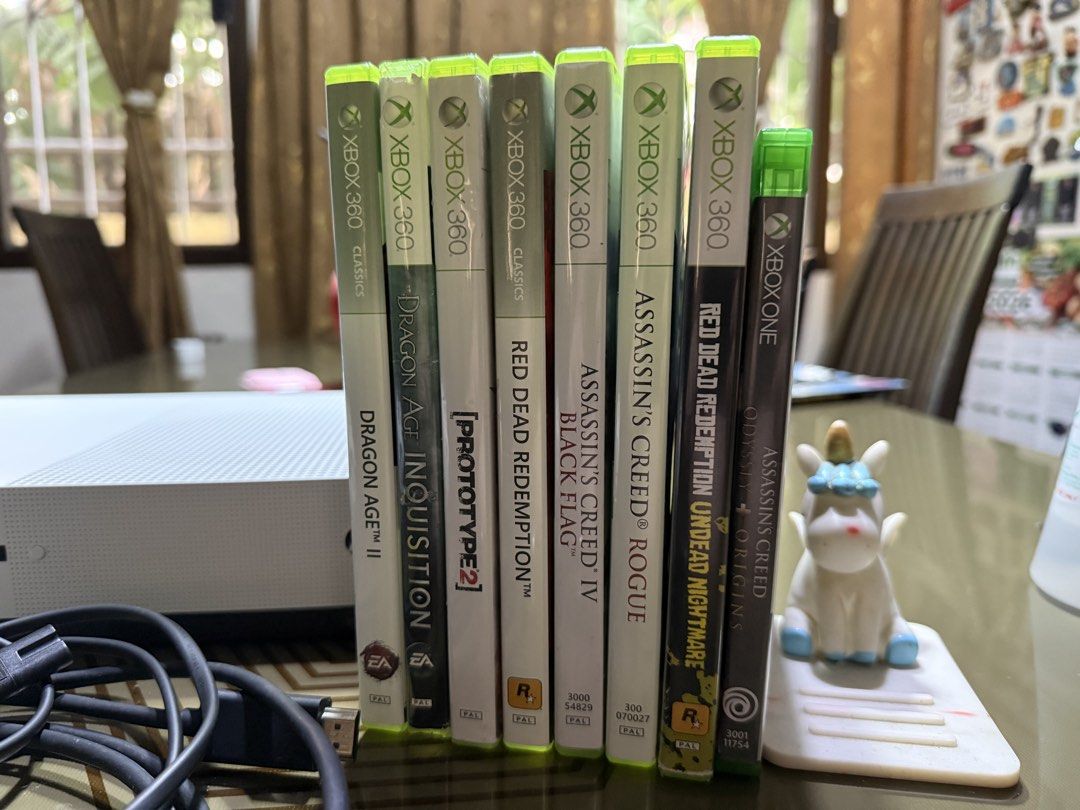 Xbox One S Bundle with Controllers and Games (Category: Xbox) located in Bulacan. Submitted by jmfranco_1101_newer (Listing ID 1470221080, Image 3). Description: - White Xbox One S console in clean condition with all back ports intact - Includes 2 white wireless controllers complete with thumbsticks and button pads (one is bnew) - Power cable and HDMI cable included - Comes with 8 popular games: Dragon Age II, Dragon Age Inquisition, Prototype 2,