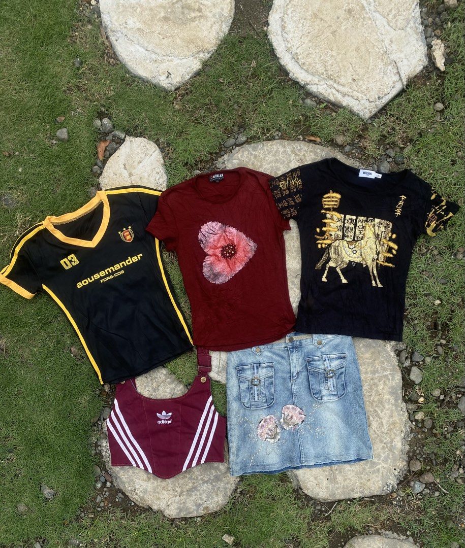 Y2K Assorted Tops and Denim Skirt Bundle (Category: Sets or Coordinates) located in Roxas City. Submitted by dua-garments23 (Listing ID 1470314885, Image 1). Description: - Bundle includes 5 trendy pieces sold as a set only - Black and yellow sports jersey style top - Maroon floral t-shirt - Black graphic shirt with gold prints - Maroon Adidas striped crop top - Light wash denim skirt with floral appliques - Mixed sizes, great for updating your w