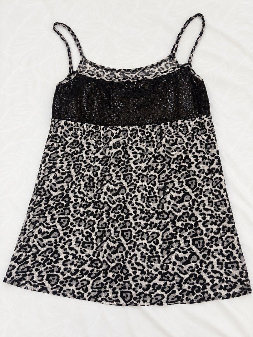Y2K Leopard Print Sequin Babydoll Cami Top (Category: Sleeveless) located in Bulacan. Submitted by shandeclutterx (Listing ID 1470219914, Image 1). Description: The cutest Y2K leopard print cami with black sequin detailing! It has dainty spaghetti straps, a sparkly bust, and a flowy babydoll silhouette. Perfect for the 2000s girlies! Super cute and versatile! You can wear it either way, depending on whether you prefer a scoop neckline or a V-shap