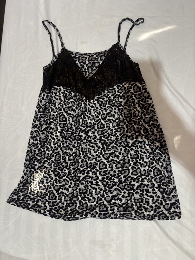 Y2K Leopard Print Sequin Babydoll Cami Top (Category: Sleeveless) located in Bulacan. Submitted by shandeclutterx (Listing ID 1470219914, Image 2). Description: The cutest Y2K leopard print cami with black sequin detailing! It has dainty spaghetti straps, a sparkly bust, and a flowy babydoll silhouette. Perfect for the 2000s girlies! Super cute and versatile! You can wear it either way, depending on whether you prefer a scoop neckline or a V-shap