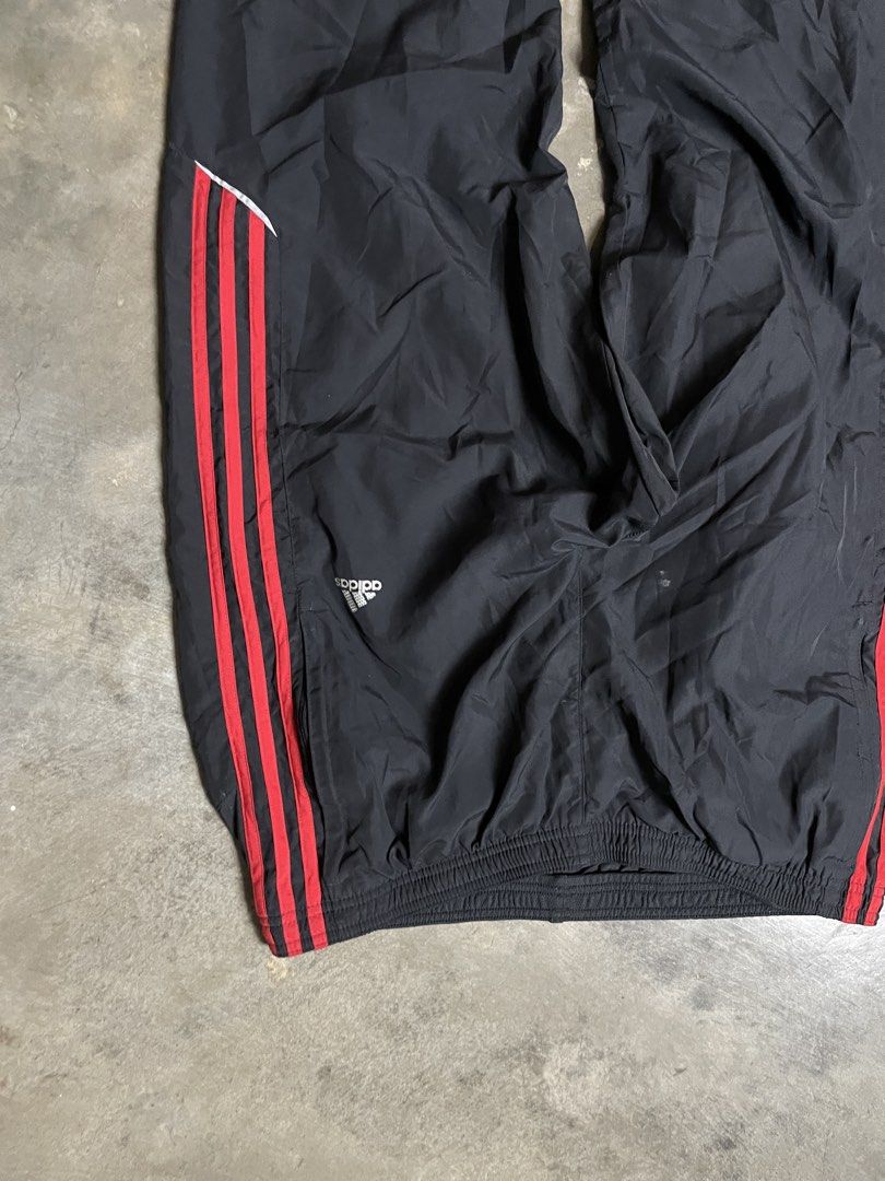 [Y2K/BLOCKCORE] Authentic 2008 Adidas Black & Red 3-Stripes Track Pants (Category: Joggers) located in Caloocan City. Submitted by piecesgarments (Listing ID 1470165447, Image 2). Description: Authentic vintage 2008 Adidas Clima365 track pants! Features a lightweight matte black shell contrasted with bold crimson red 3-Stripes, silver reflective piping trim, embroidered logo on the hip, ankle leg zippers, and full interior mesh lining. DETAILS: •