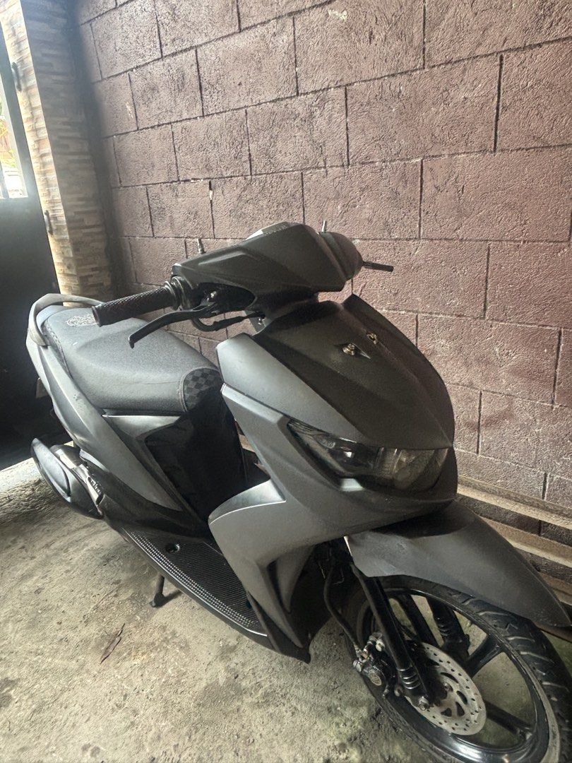 Yamaha Mio Scooter Matte Black (Category: Motorbikes for Sale) located in Caloocan City. Submitted by ethelle_1122 (Listing ID 1470197659, Image 2). Description: Matte black Yamaha automatic scooter. Compact size, great for daily city rides. Clean body panels and standard black rims. Front disc brake setup. Dual tires in 14-inch size mounted on black alloy wheels. Exhaust pipe features a Yamaha heat shield. Standard single seat with textured patt