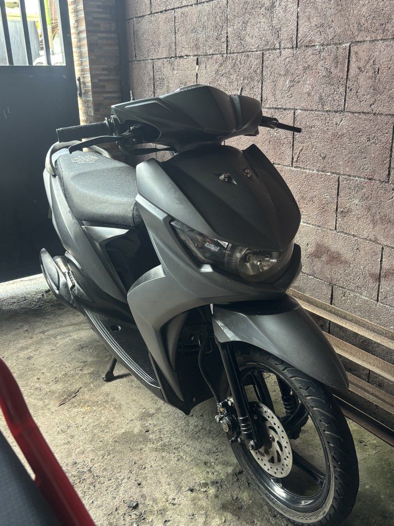 Yamaha Mio Scooter Matte Black (Category: Motorbikes for Sale) located in Caloocan City. Submitted by ethelle_1122 (Listing ID 1470197659, Image 1). Description: Matte black Yamaha automatic scooter. Compact size, great for daily city rides. Clean body panels and standard black rims. Front disc brake setup. Dual tires in 14-inch size mounted on black alloy wheels. Exhaust pipe features a Yamaha heat shield. Standard single seat with textured patt