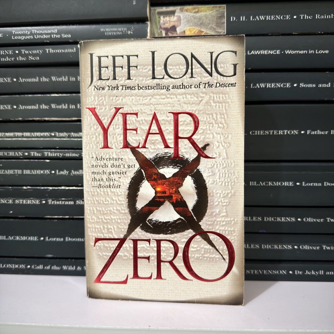 Year Zero by Jeff Long Novel Paperback (Category: Storybooks) located in Lingayen. Submitted by readwjane (Listing ID 1470200493, Image 1). Description: - Title: Year Zero - Author: Jeff Long - Genre: Suspenseful adventure - Format: Paperback - Condition: Standard reading copy - Design: Striking cover with ancient text background and bold red lettering.