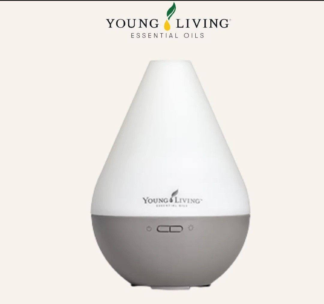 Young Living Dewdrop Essential Oil Ultrasonic Diffuser (Category: Home Fragrance) located in Manila. Submitted by lenzp (Listing ID 1470163046, Image 2). Description: - FREE DELIVERY WITHIN MANILA OR QC - Authentic Young Living Dewdrop Ultrasonic Essential Oil Diffuser - Includes original purple box - Water reservoir capacity: 180 ml - Coverage area: ~323 sq. ft. / 30 sq. meters - Compact dimensions: 13.5 x 13.5 x 19 cm (~6.3 x 5.3 x 7.5 inches) 