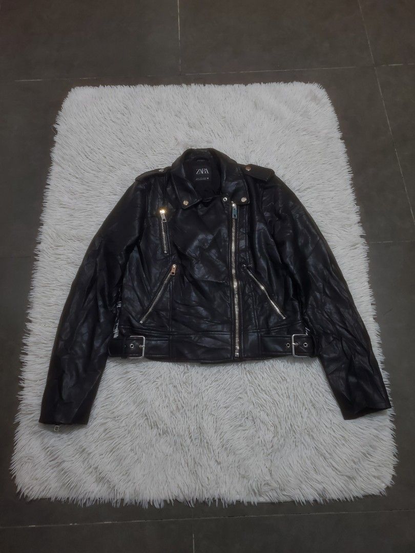 Zara Black Faux Leather Biker Jacket (Category: Coats, Jackets and Outerwear) located in Manila. Submitted by royalrabbit.7b2a11 (Listing ID 1470219536, Image 1). Description: - Brand: Zara - Style: Black faux leather biker jacket - Size: M - Hardware: Silver-tone with zippers on front and sleeves - Features: Adjustable waist belt with buckle closure, classic lapel collar with snap buttons - Origin: Made in Myanmar.