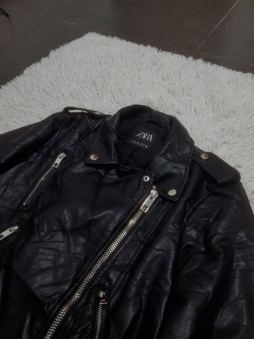Zara Black Faux Leather Biker Jacket (Category: Coats, Jackets and Outerwear) located in Manila. Submitted by royalrabbit.7b2a11 (Listing ID 1470219536, Image 3). Description: - Brand: Zara - Style: Black faux leather biker jacket - Size: M - Hardware: Silver-tone with zippers on front and sleeves - Features: Adjustable waist belt with buckle closure, classic lapel collar with snap buttons - Origin: Made in Myanmar.