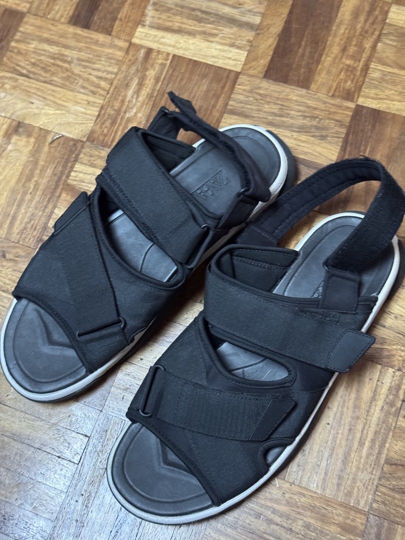 Zara Black Sandals Size 45 (Category: Flats & Sandals) located in Manila. Submitted by seangoart (Listing ID 1470190681, Image 1). Description: - Brand: Zara - Color: Black with chunky white and black sole - Size: 45 (stamped on footbed) - Features: Adjustable velcro straps across front and heel for a secure fit - Condition: Worn a few times, minimal wear on soles - Perfect for: Everyday casual wear in warmer weather.