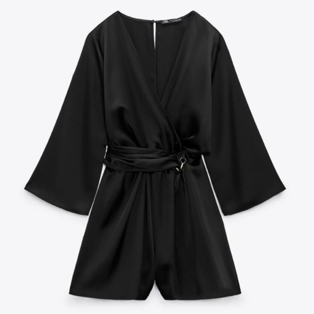 Zara Black Satin Romper Size XS (Category: Rompers) located in Cebu City. Submitted by _t.rix (Listing ID 1470187466, Image 1). Description: - Brand: Zara - Style: Black satin romper with V-neck crossover front - Size: XS (EUR XS, USA XS, MEX 24) - Features: Flare sleeves, attached waist tie with side loop, back button closure with keyhole cutout - Material: Smooth, shiny fabric - Condition: Clean and ready to wear.